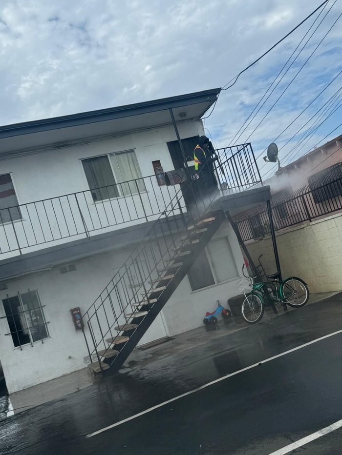 Exterior apartment stairway and walkway being washed