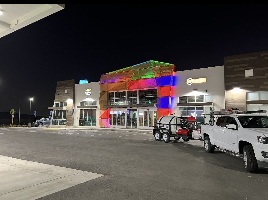 Large illuminated commercial center with service vehicles